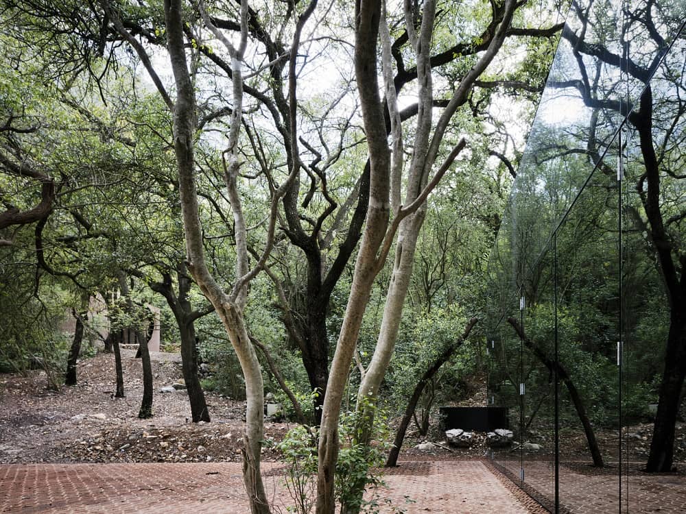 Mirrored Glass House in a Forested Hillside of Monterrey by Architect Tatiana Bilbao